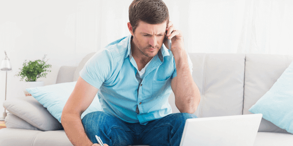 Man on phone with laptop